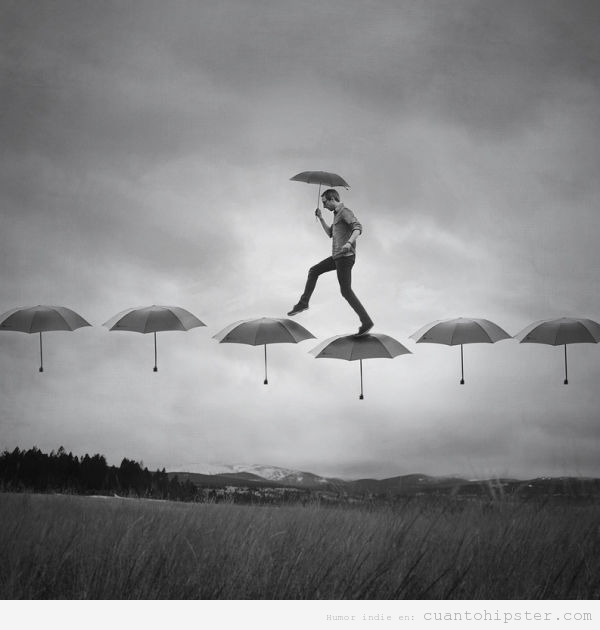 Imagen bonita de un hombre caminando sobre paraguas
