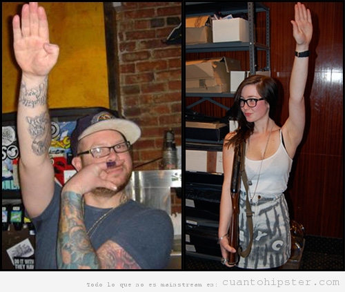 Chico y chica hipster con la mano alzada Heil Hipster, Adolf hitler hipster