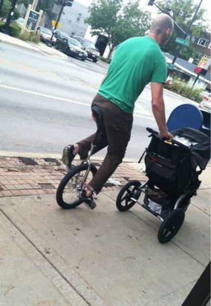 Padre hipster paseando al bebé en en monociclo