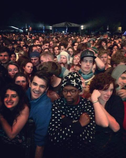Foto graciosa de un hipster aburrido en un concierto